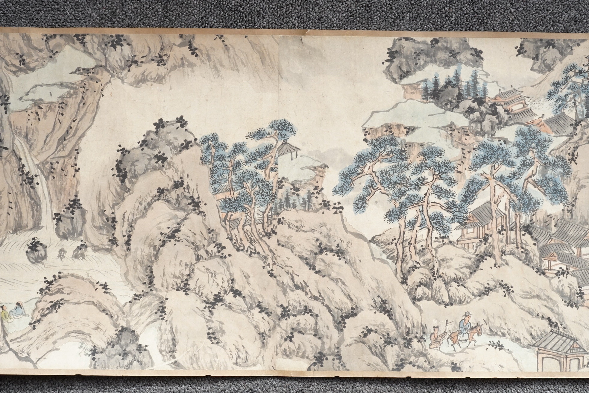 Chinese School , (Qing dynasty), Figures in a mountainous river landscape, Ink and colour on paper handscroll, 268.5cm x 29cm excluding borders